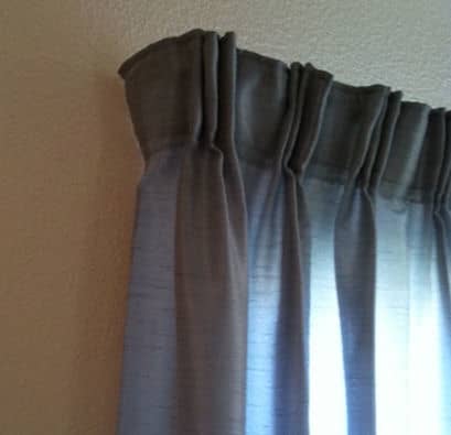 Wrapping the drapery around the end of the rod gives privacy, and keeps out light that will wake you in the mornings.