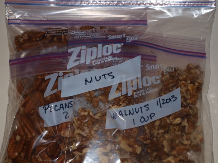 Small bags of nuts are placed inside a larger freezer bag for protection against food odors and dampness.
