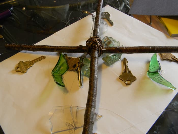 Here's an example of a chime body made from two straight sticks wrapped with vine. It uses keys and bits of glasses as noisemakers.
