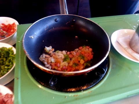 How to cook an omelette in a frying pan: Preheat a non-stick pan, add butter and the five ingredients and saute for about 3 minutes