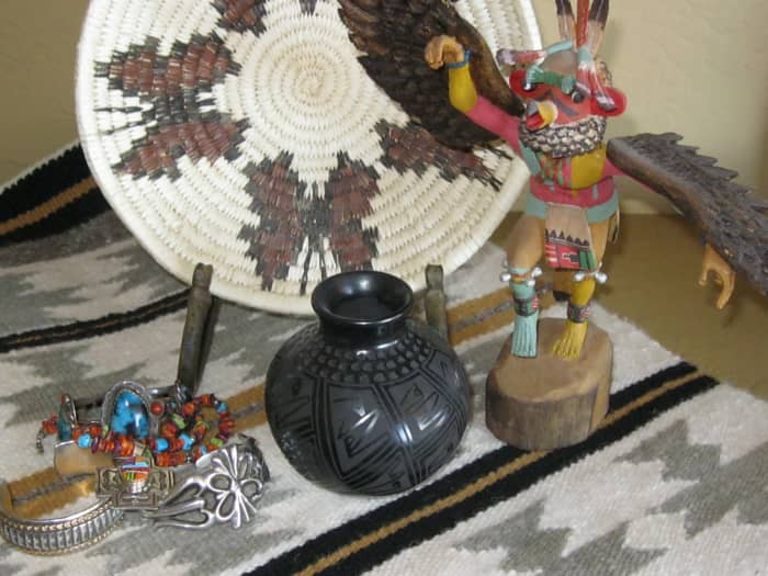 Butterfly basket, eagle dancer kachina, black Pueblo pot, crystal pattern Navajo rug, assorted jewelry.