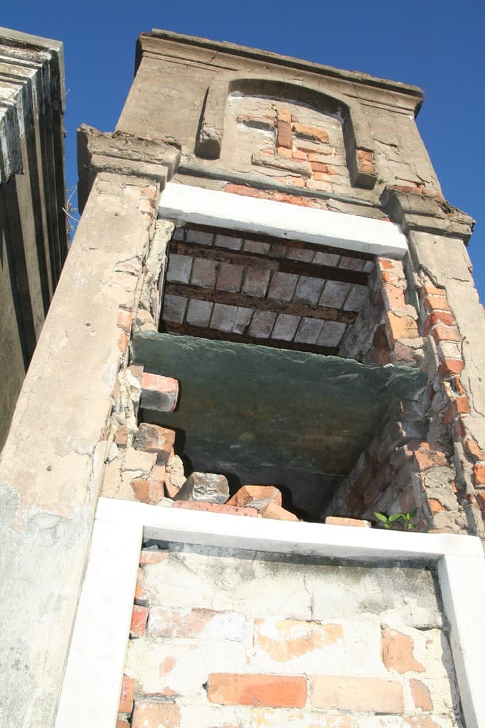 Some societies are tiny, small groups of artisans who band together like these black businessmen. The front of the tomb has broken and fallen away, showing the shelving inside.