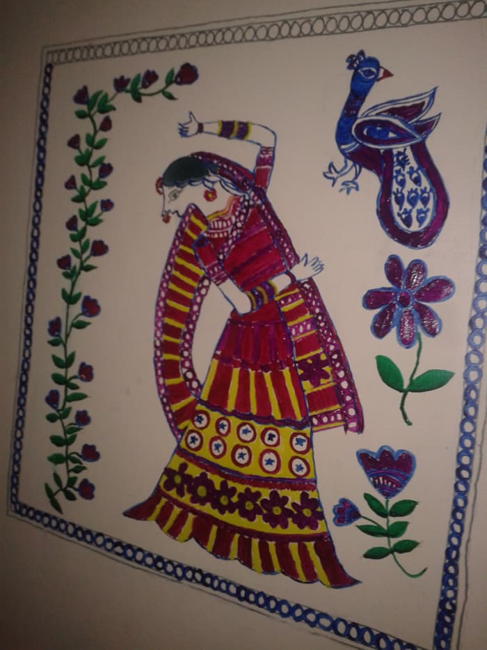 Madhubani wall painting of a woman dancing. A bunch of flowers and peacock are painted as the accompanying themes.