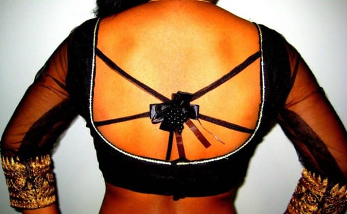 A blouse is not a gift wrapped with a ribbon. So please avoid these type of sari back design—as you can see, they're not very appealing.