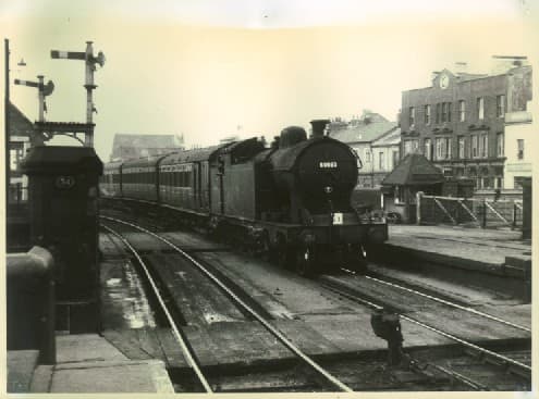 A8 4-6-2T with non-corridor stock enters Middlesbrough Station over Sussex Street level crossing from Thornaby (Darlington) direction with a train of mixed pre-1948 passenger stock. These locos were rebuilt in 1920s from Raven H1 4-4-4T
