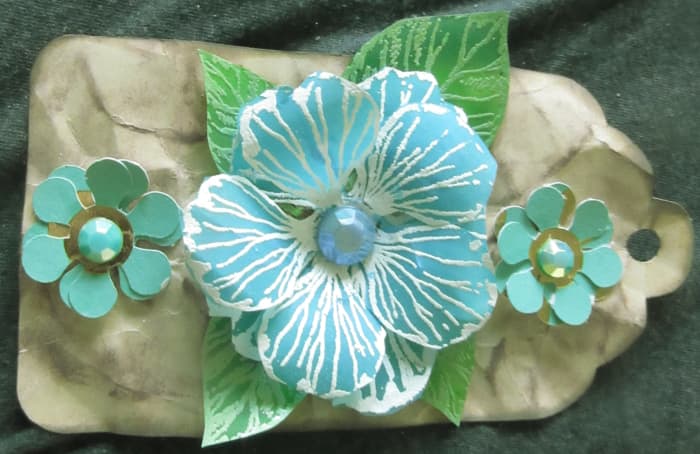 Vellum can be used to make wonderful flowers. It can be started as a white or neutral, then be colored with any color you would like, once it has been die cut.