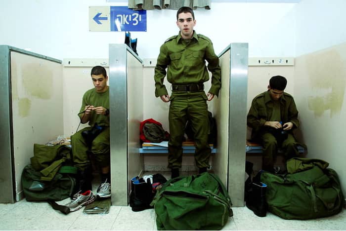 Roman conscripts trying on uniforms for the first time. At the completion of two years service, these civilians would become citizens.