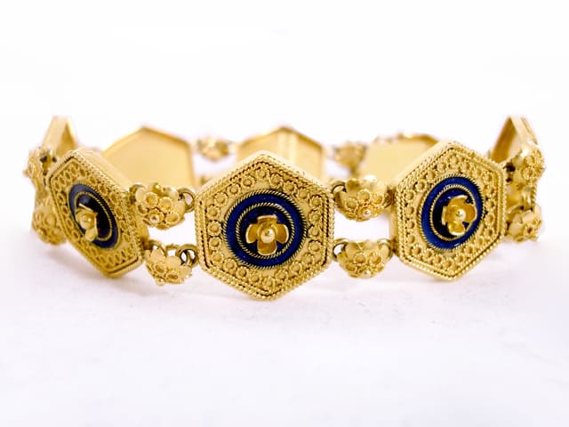 15 kt yellow gold flexible Castellani bracelet featuring fantastic milgraining and wonderful rich blue enameling.
