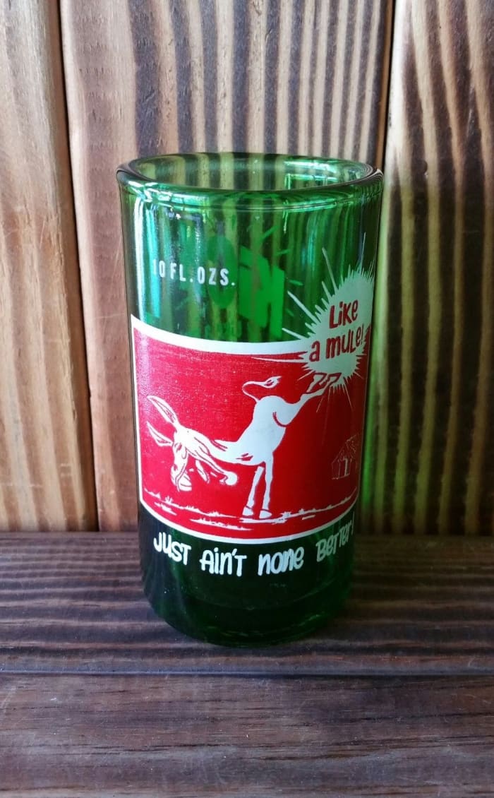This vintage glass is made from an upcycled KICK soda bottle. Each glass is flame cut and polished to give you a smooth finished rim.