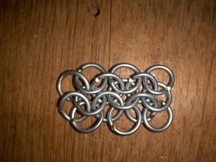 The 13 link rectangle made in the first tutorial. An additional 2 rings have been added to the left hand edge to begin the triangle.