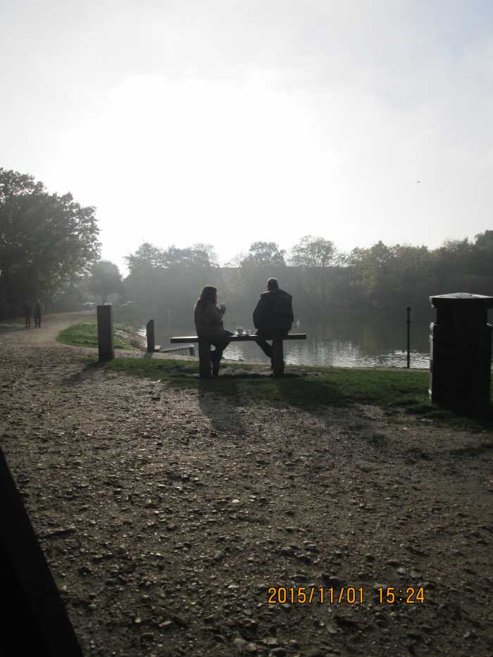 Autumn is well and truly in the air at around four in this Sunday afternoon shot. A conversation takes place on the lakeside bench ahead