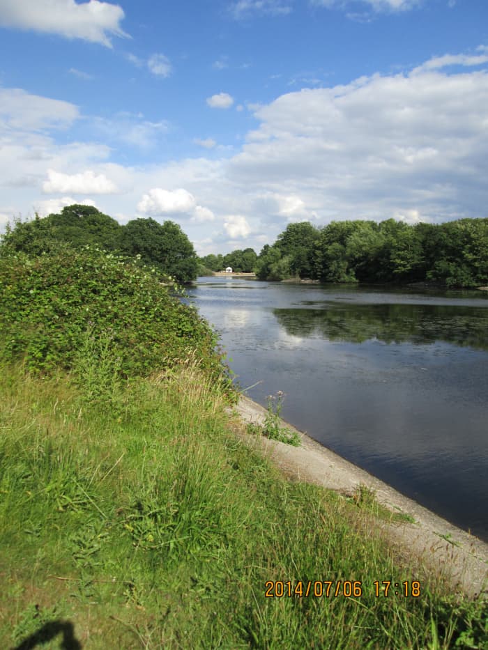 Looking back the length of the Heronry Pond at the refreshment kiosk between one of the eyots and the shore