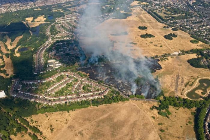 An aerial view looking eastward. The police were on the verge of evacuating the housing estate (left) before the fire was eventually controlled.