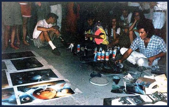 Gerardo Amor doing spray paint art on the Malecon of Puerto Vallarta, Ruben Melody is to his left
