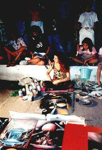Alisa Amor painting on the Malecon of Puerto Vallarta, notice the student behind her taking careful note