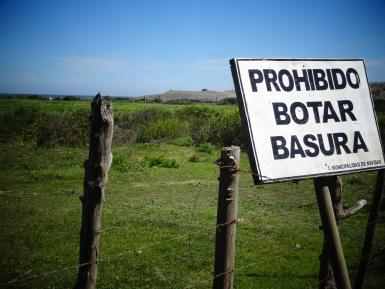 This sign reads "Throwing Away Trash is Prohibited Here." What is prohibited? Throwing trash away. The act of throwing away the trash, or littering, is prohibited and is being used as a noun.