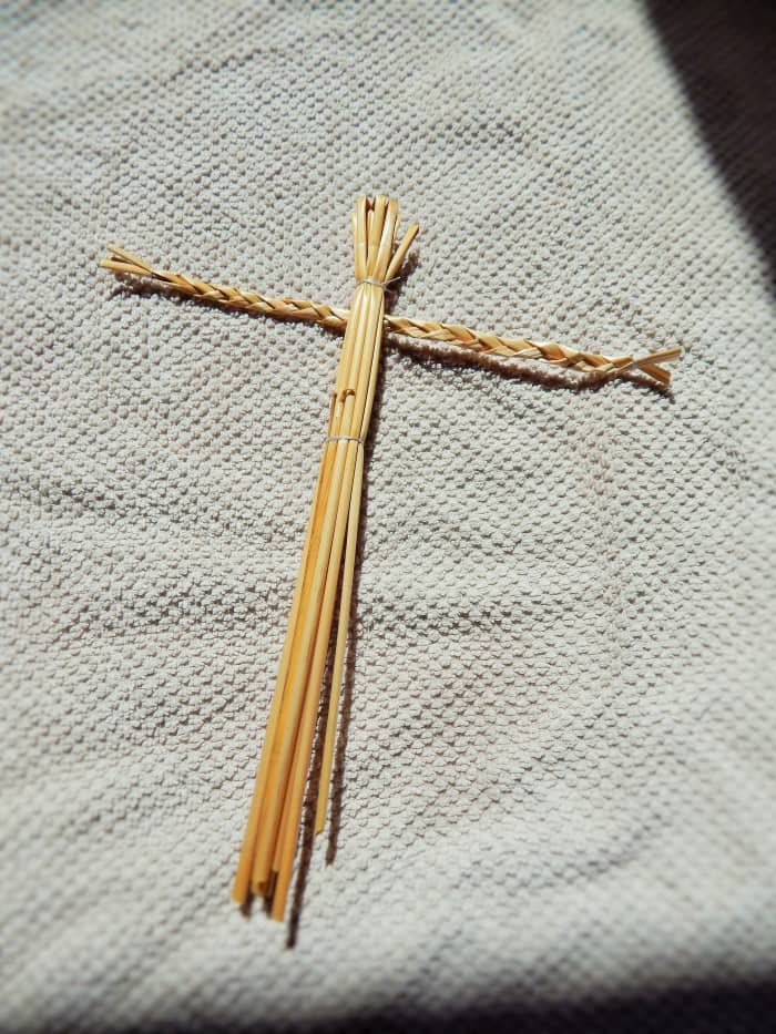 Fig. 4. Feed the arm piece of your Straw Man through the body, then tie the bottom of the body tightly with string to make secure.