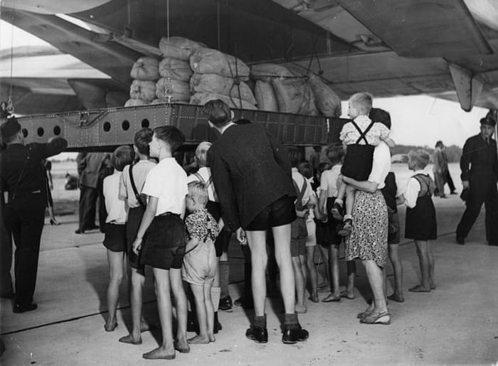 A U. S. Air Force C-74 Globemaster plane unloading more than 20 tons of flour from the United States (Aug 19, 1948) at RAF Gatow (British airfield in southwest Berlin)