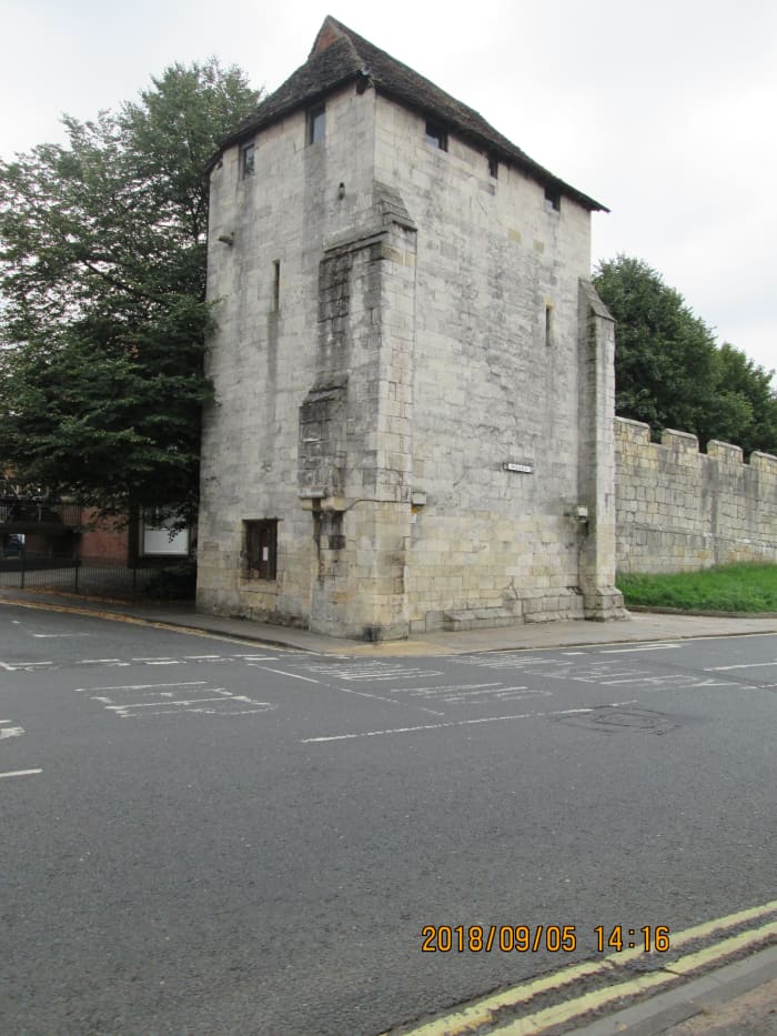 Tower Street, opposite the Travelodge hotel, you'll find this handsome structure that provides access to the wall walk. There are no hard and fast rules about which direction to take as long as you don't obstruct others. What you're looking at is...