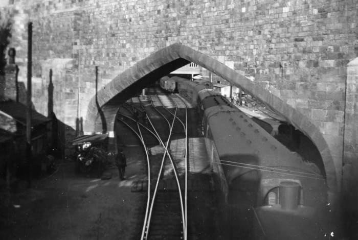 The archway through which trains from north and south met to enter York's older station. Carriages being moved through the arch by a diesel shunter, late 1950's or early 1960's after the steam station pilots were transferred to Newcastle-upon-Tyne