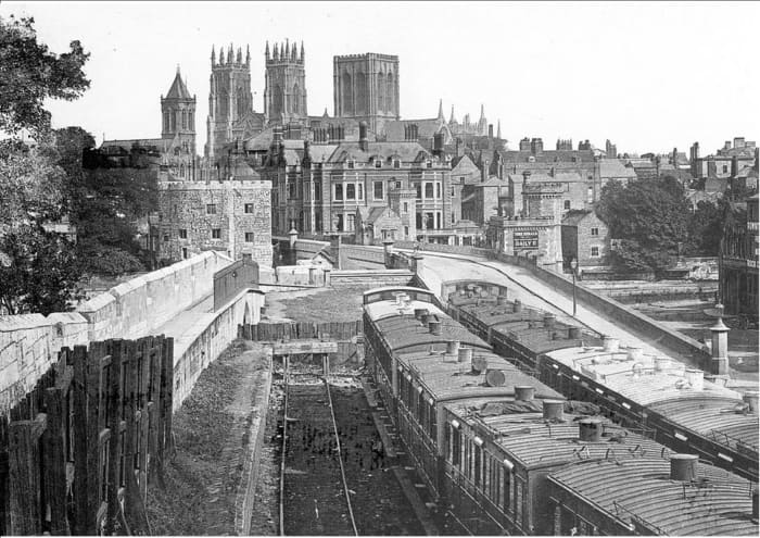 This is Lendal Bridge in 1868 and shows where the city wall stops at one of the bridge structures shown above. Beside the wall is where carriage sidings ran from the old pre-1877 railway station (behind you in this view)