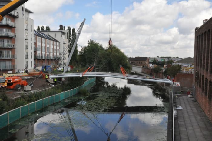 Hungate's modern footbridge, astride the River Foss near Foss Harbour seen here under construction