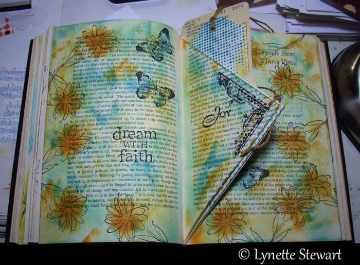 Creating in your altered book means that you are not limited in how you create your layouts, Here the artist uses creative folds in her book
