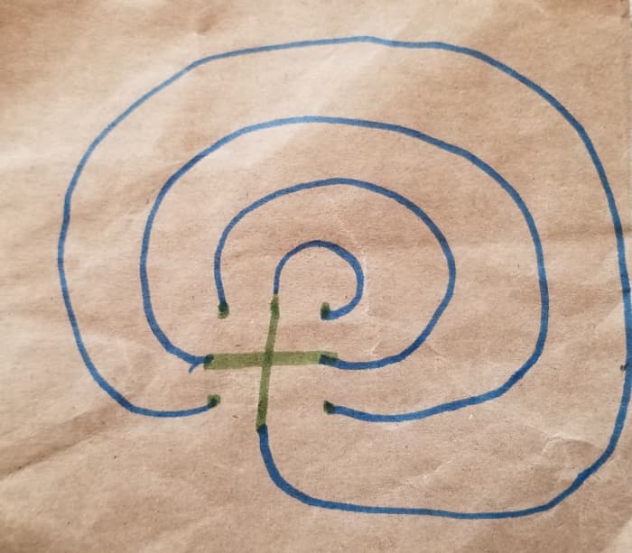 Step 5: Finish drawing the labyrinth with the final left-to-right arc from the bottom left dot, up all the way around to the bottom tip of the vertical beam of the cross.