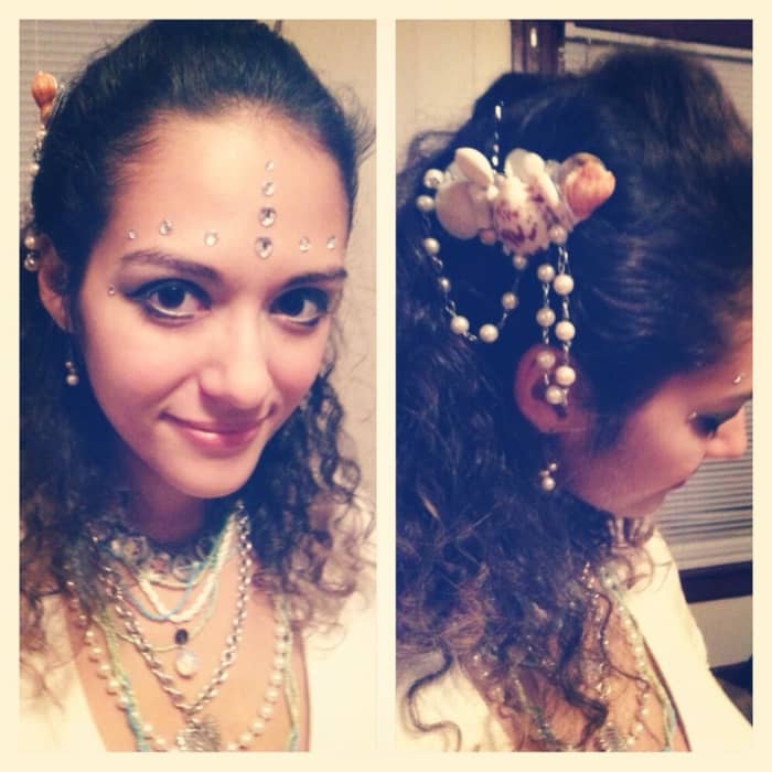 Shell barrette made with tiny mirrors, shells, a foe pearl necklace, and hot glue. Layered accessories pillaged from sunken ships and rhinestone scales.