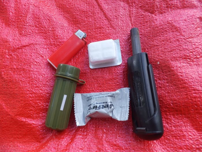 Carry a few methods of starting a fire and a few fire starters. Here are matches, a lighter, and a UST blast match.