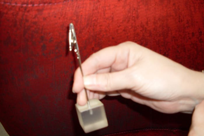 Figure 1. Easy to hang on to because of the weighty glass base, and easy to use because of the alligator clip on the end of a sturdy rod.