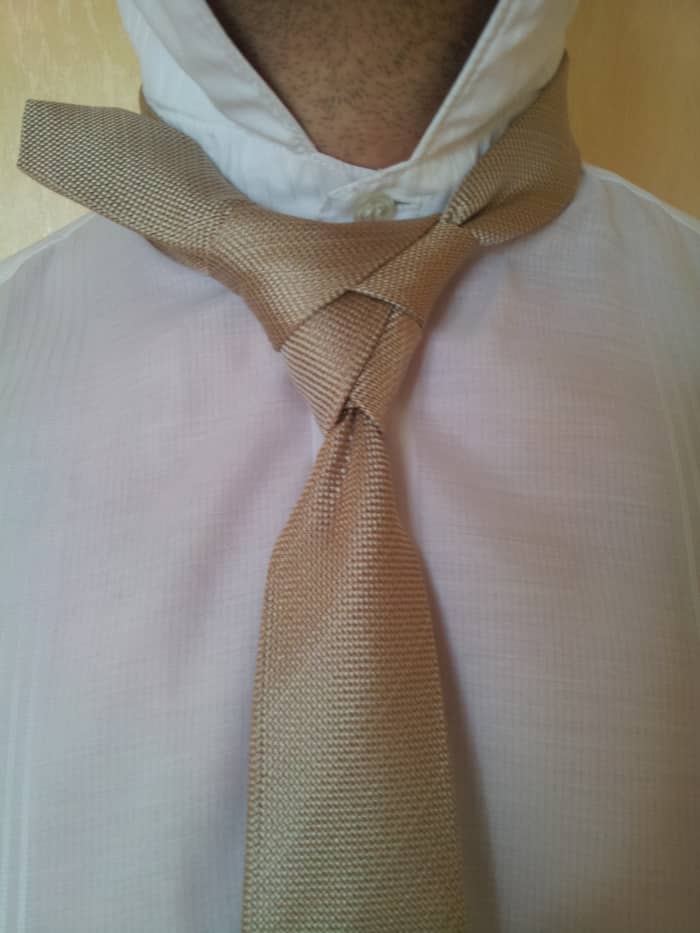 Step 13. Keep the knot loose enough and go through the loop on top, pull through and tighten the knot.