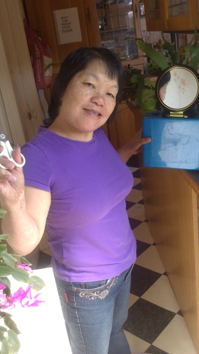 This is me with the small mirror for use to see the back of my head. The big mirror is behind me on the wall.