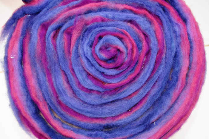 The pencil roving makes it easy to make a circular patter around the seat area. Take car to cover the surface so that the wood does not show through.