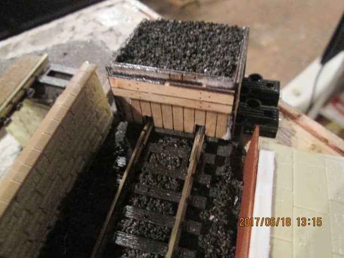 Poppy's Woodtech sleeper-built buffer stop with cinder ballast topping seen from the platform side, the buffer stop still to be secured and durable enough to withstand transit.
