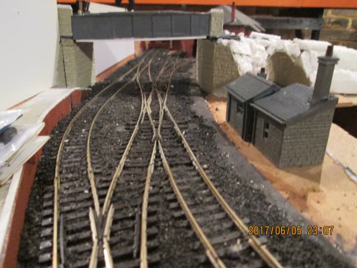 Things are looking up. Notice the white plastic sheeting against the back wall. This is where sheets of 1D self-adhesive printed scenery will be mounted