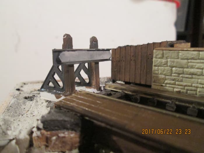 The end of the line... One of the pairs of cast brass North Eastern Railway style buffer stop sides from Slaters now completed, with plastic posts and beam from the Evergreen strip styrene range... seen from from front