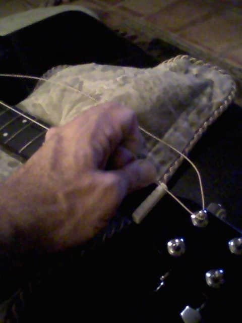 As you wind the string tight--I prefer not to use the winder for this--it's important to keep tension on the string, both on the peg side and on the bridge side.