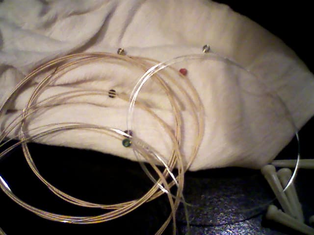 A set of new strings, just out of the envelope. These are D'Addarios, and have color-coded ball ends.