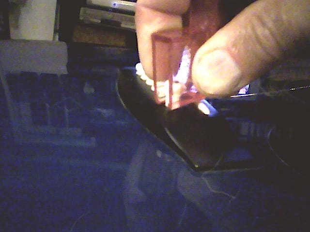 Removing bridge pegs. Much easier working from the direction of the strings! (That is, with the peg remover resting on the bridge saddle.)