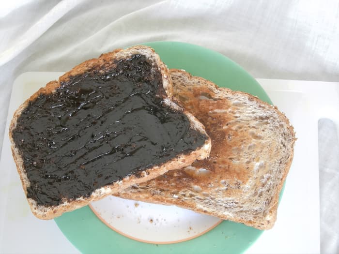Thickly-spread marmite on toast; I love marmite, but I would never spread it this thick! I like it when patches of butter, margarine or other spread are showing in between patches of marmite.
