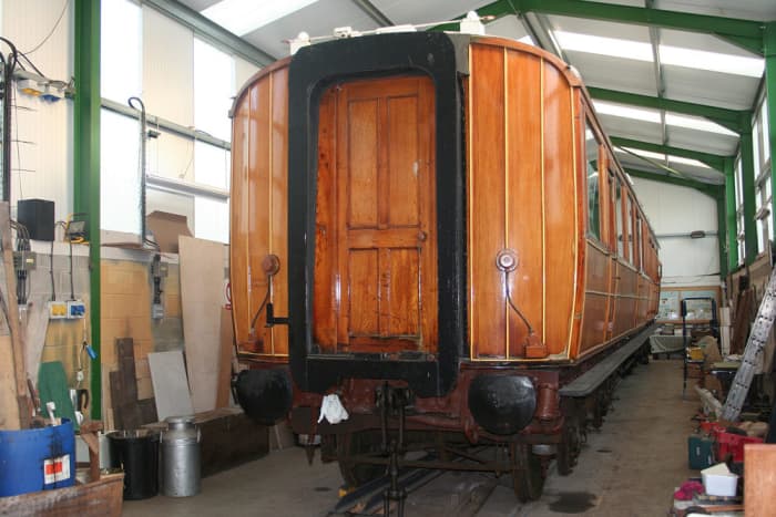 Work complete on a carriage, the corridor connection sets off the panel work and underframe paintwork