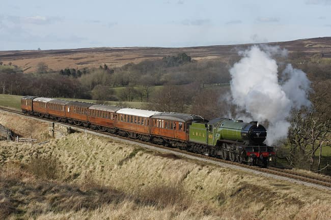 Preserved Class V2 4771 'Green Arrow' takes a rake of restored LNERCA Gresley stock for a spin near the highest point of the NYMR line into Newtondale past Fylingdale's early warning station