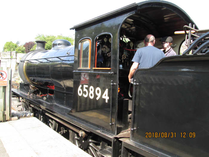 A footplate visitor is shown around - there's a lot to take in, with levers, dials and brakes (both on the locomotive and tender)