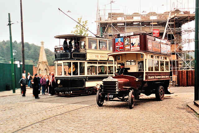Beamish street scene with early double-decker ('knife-board') bus passing a double-decker tram. Double-decker trams were still fairly common on Britain's city and town streets until the mid-1950s