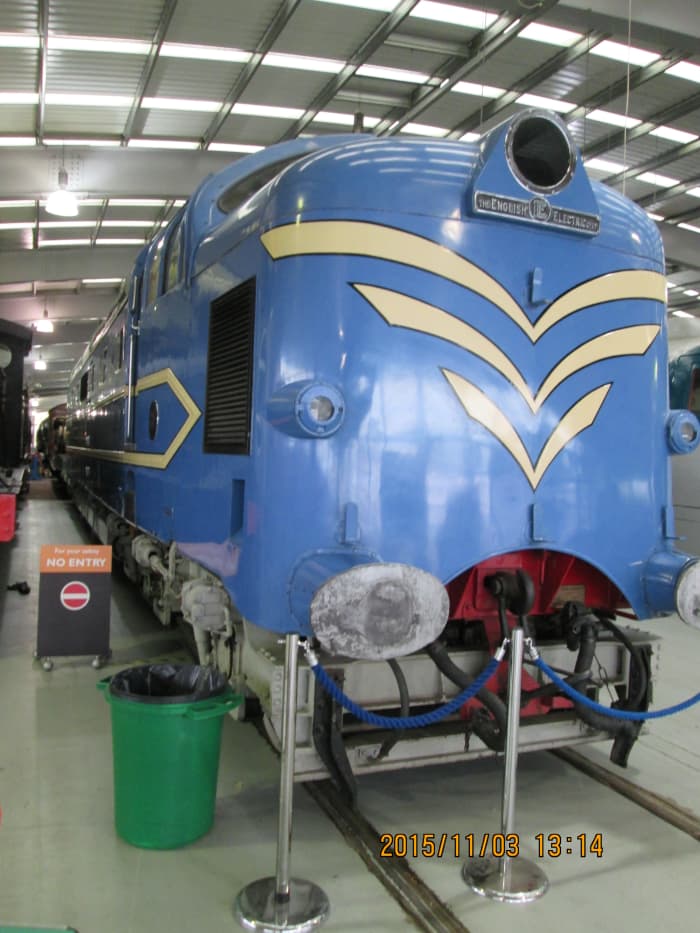 Prototype blue 'Deltic' diesel, 'Alycidon' with speed whiskers poses on the floor of the museum adjacent to 'Green Arrow'