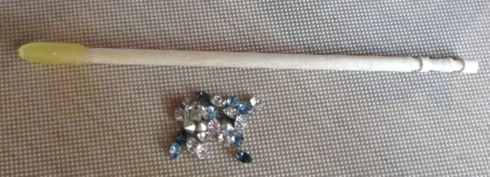 To pick up tiny objects, like those Swarovski crystal chatons, I suggest using a beeswax-tipped toothpick or other jewel pick.