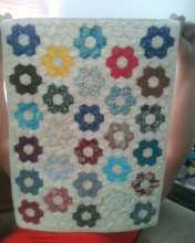 This particular miniature quilt took over 100 hours to hand piece; the hexagons are one inch wide.