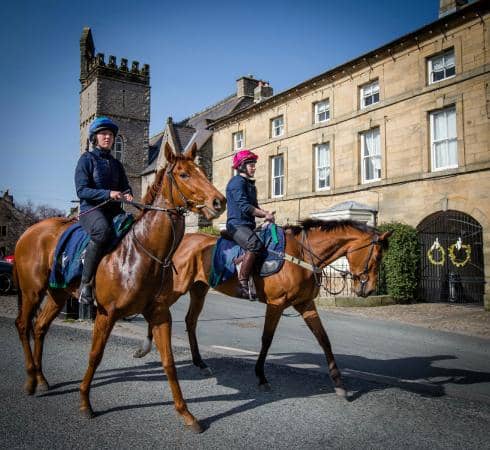 Racehorses return from exercises on the gallops by the Coverham road, seen here before reaching the market square (the photographer stood to the right of the road, near where the previous image was taken)