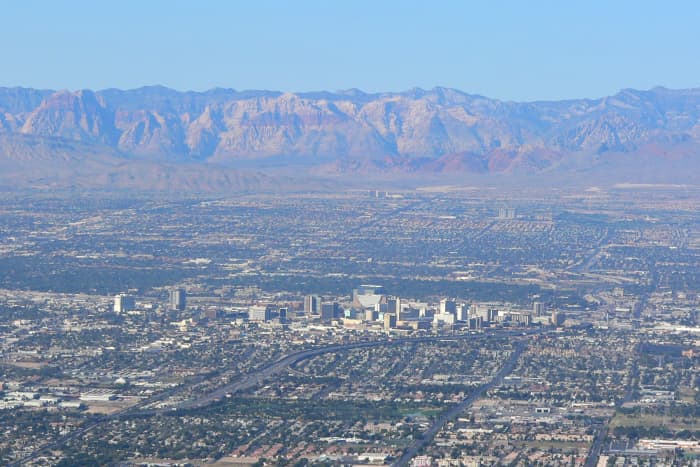 Looking west from Frenchman Mountain across Las Vegas. Las Vegas Strip (center). Red Rock Casino and beautiful Red Rock Canyon are in the distance.